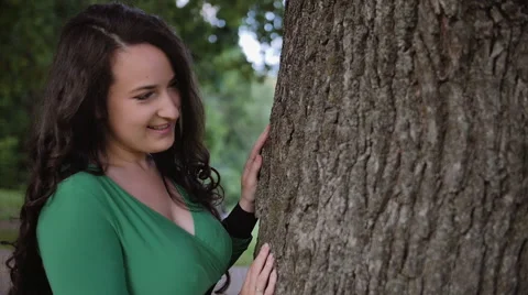 Cute young couple leaning on tree in park on nice summer day Stock Footage 65471179
