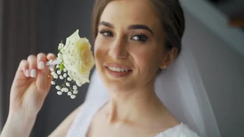 Cute young female posing with flowers in hands. Pretty stylish caucasian woman Stock Footage 206070007