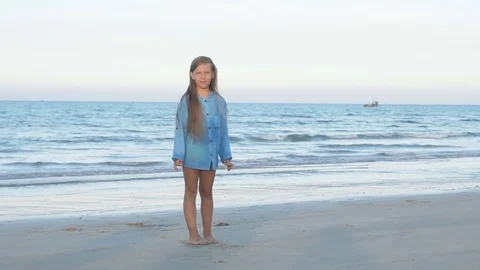 Cute young girl doing split on the beach Stock Footage 79032163