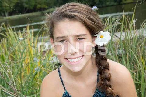 Cute young girl with a flower in the park Stock Photos