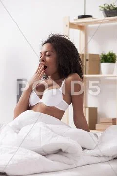 Cute young girl is gaping after sleeping Stock Photos