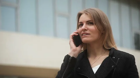 Cute Young girl talking on the phone on the street Stock Footage 111864341