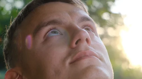 Cute young guy looking to the sky, close-up Stock Footage 112930118