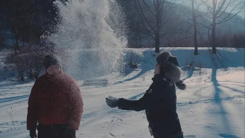Cute young hipster couple having fun in winter park on a bright day hugging each Stock-Footage 72409482