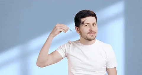 Cute young man doing his grooming routine in the bathroom. Man removing his Stock Footage 235660354