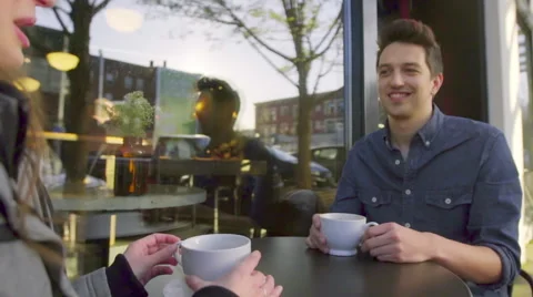 Cute young man drinks coffee outside cafe Stock Footage 61716745