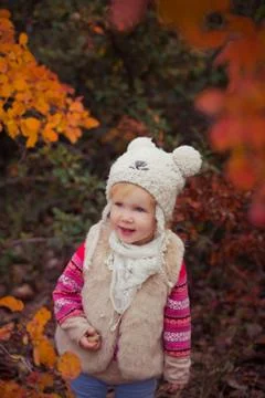 Cute young russian baby girl stylish dressed in warm white fur handmade jacke Stock Photos