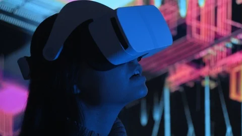 Cute young woman uses interactive VR headset, amaze and enjoys virtual reality Stock Footage 94779939