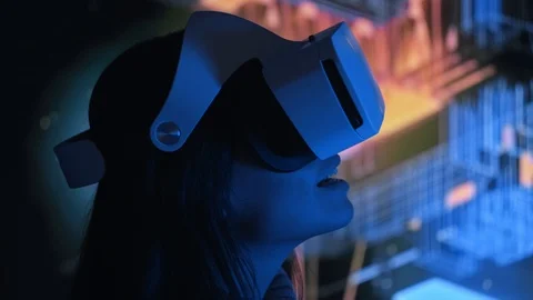 Cute young woman uses interactive VR headset, laughs and enjoys virtual reality Stock Footage 94883380