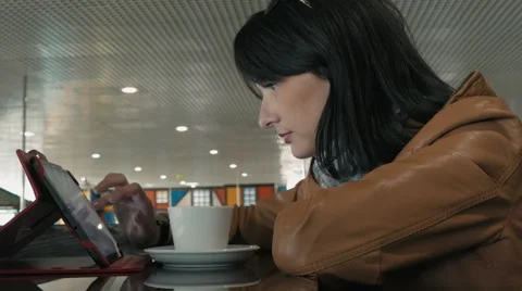 Cute Young Woman Using Tablet PC In Cafe Stock Footage 62593517