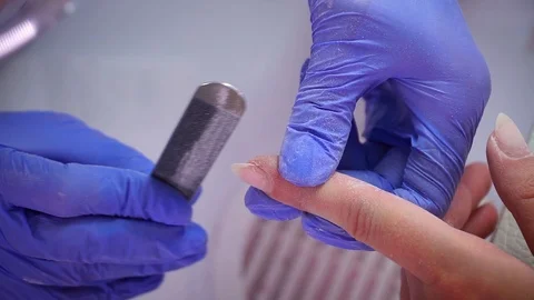 Cuticle removal with a tool middle finger Stock Footage 103830699