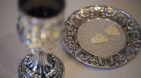Cutleries, made from silver, stand on table covered with white tablecloth Video stock 65785125