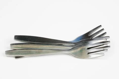Cutlery arranged on a white kitchen table. Accessories for kitchen and restau Stock Photos