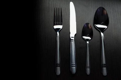 Cutlery on a black table Stock Photos