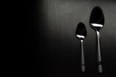 Cutlery on a black table Stock Photos