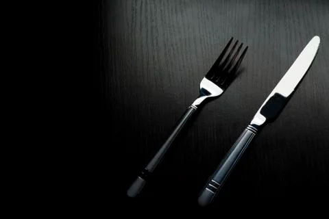 Cutlery on a black table 스톡 사진