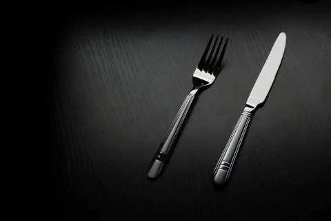 Cutlery on a black table Stock Photos