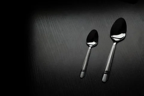 Cutlery on a black table Stock Photos