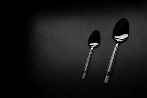 Cutlery on a black table 스톡 사진