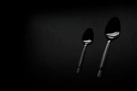 Cutlery on a black table Stock Photos