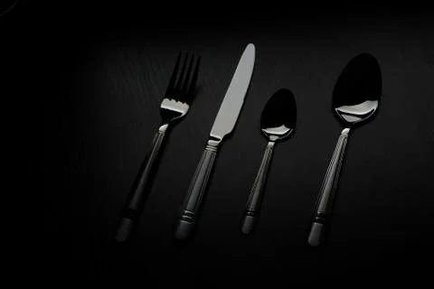 Cutlery on a black table Stock Photos