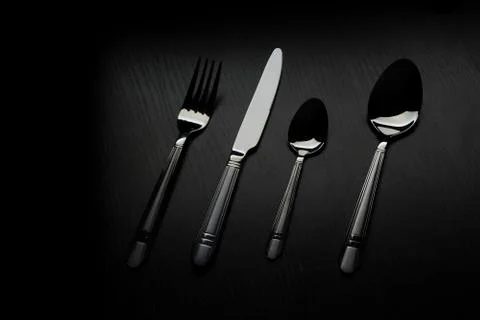 Cutlery on a black table Stock Photos