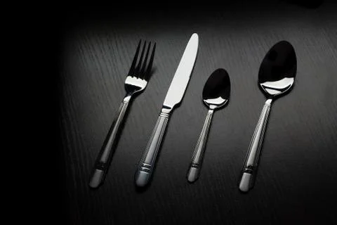 Cutlery on a black table Stock Photos