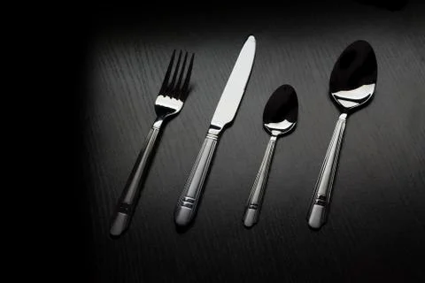 Cutlery on a black table Stock Photos