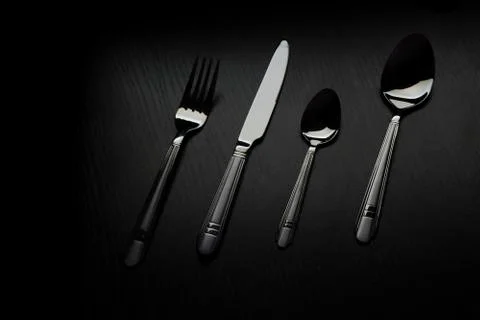Cutlery on a black table Stock Photos