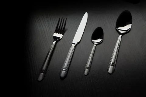 Cutlery on a black table 스톡 사진