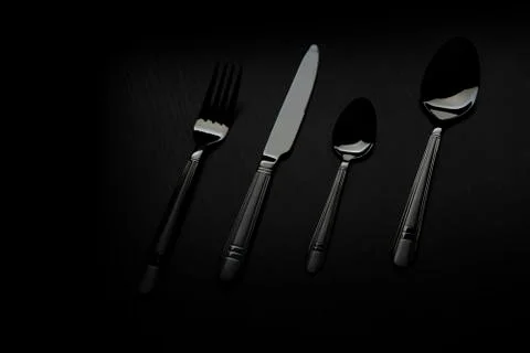 Cutlery on a black table Stock Photos