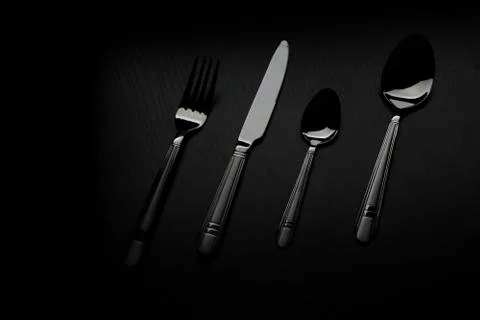Cutlery on a black table 스톡 사진