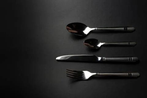 Cutlery on dark table Stock Photos