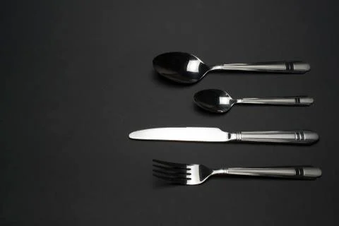 Cutlery on dark table Stock Photos