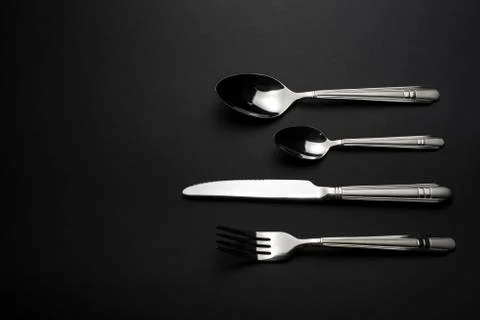 Cutlery on dark table Stock Photos