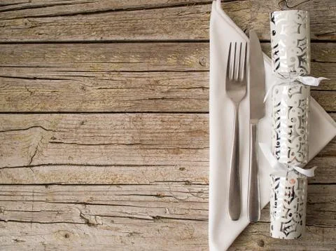 Cutlery kitchenware and cracker on old wooden boards background Stock Photos
