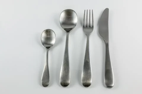 Cutlery with knife, fork, table spoon and little spoon Stock Photos