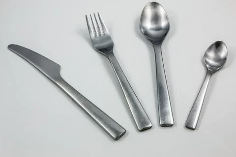 Cutlery with knife, fork, table spoon and little spoon Stock Photos
