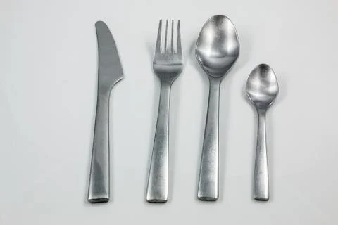 Cutlery with knife, fork, table spoon and little spoon Stock Photos