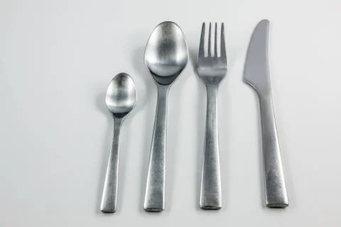 Cutlery with knife, fork, table spoon and little spoon Stock Photos