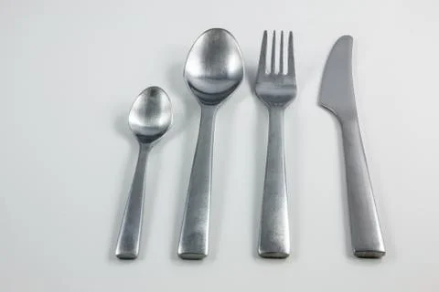 Cutlery with knife, fork, table spoon and little spoon 库存照片