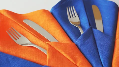 Cutlery for table setting. Forks and knives in table napkins Stock Footage 93876974