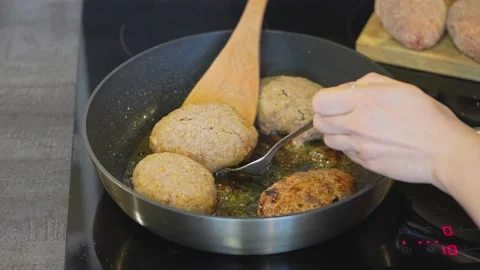 Cutlet in a pan, the beginning of the cooking process. Juicy delicious cutlets Stock Footage 155397948