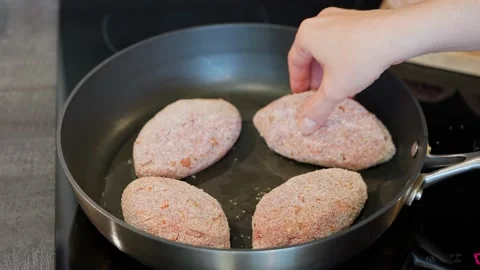 Cutlet in a pan, the beginning of the cooking process. Juicy delicious cutlets Stock Footage 155892589