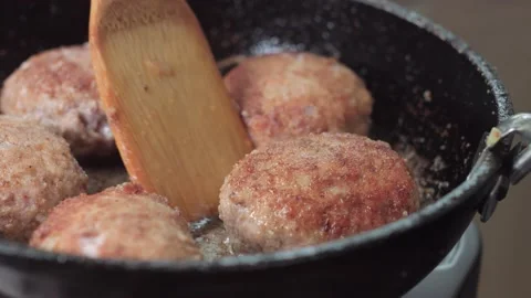 The cutlet is turned over in a pan Stock Footage 142930184