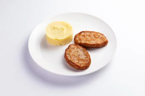 Cutlets and mashed potatoes in a plate. Stock Photos