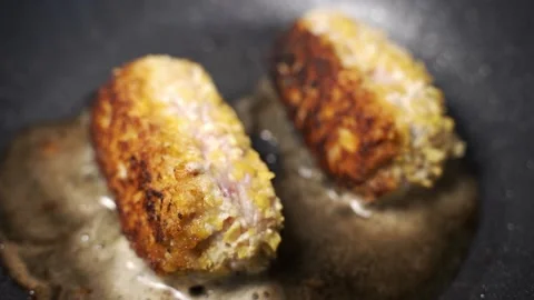 Cutlets are fried in a pan close-up Stock Footage 153658403