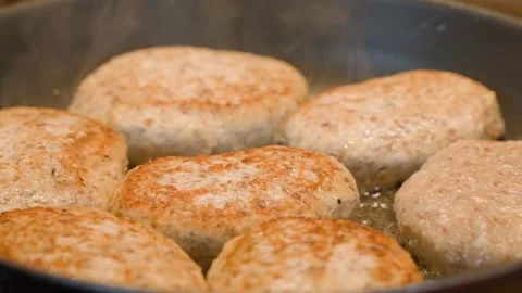 Cutlets being fried in a pan close-up in slow motion Stock Footage 309544867