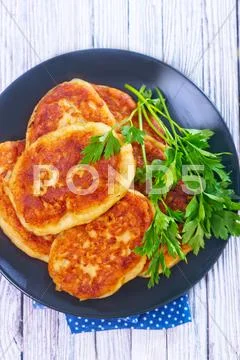 Cutlets on black plate on a table Stock Photos