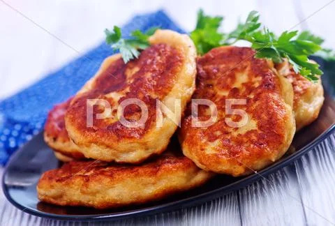 Cutlets on black plate on a table Stock Photos